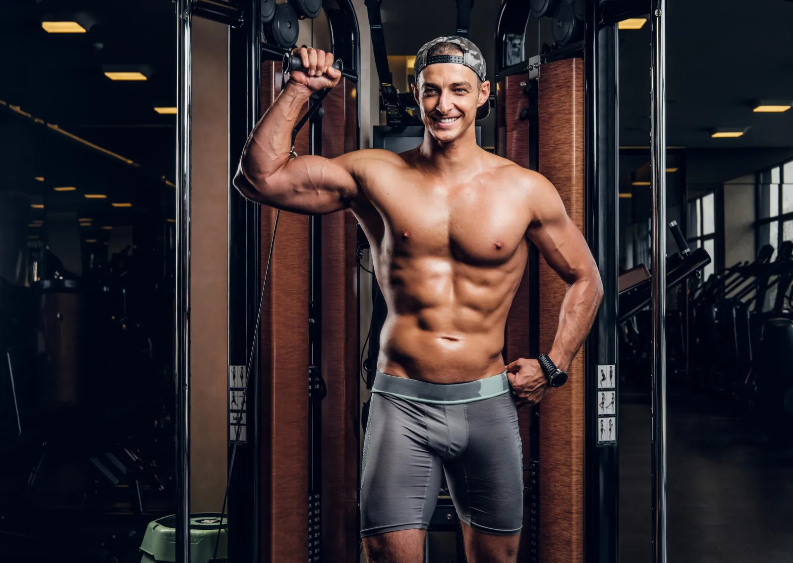 Man training on a cable machine in a gym