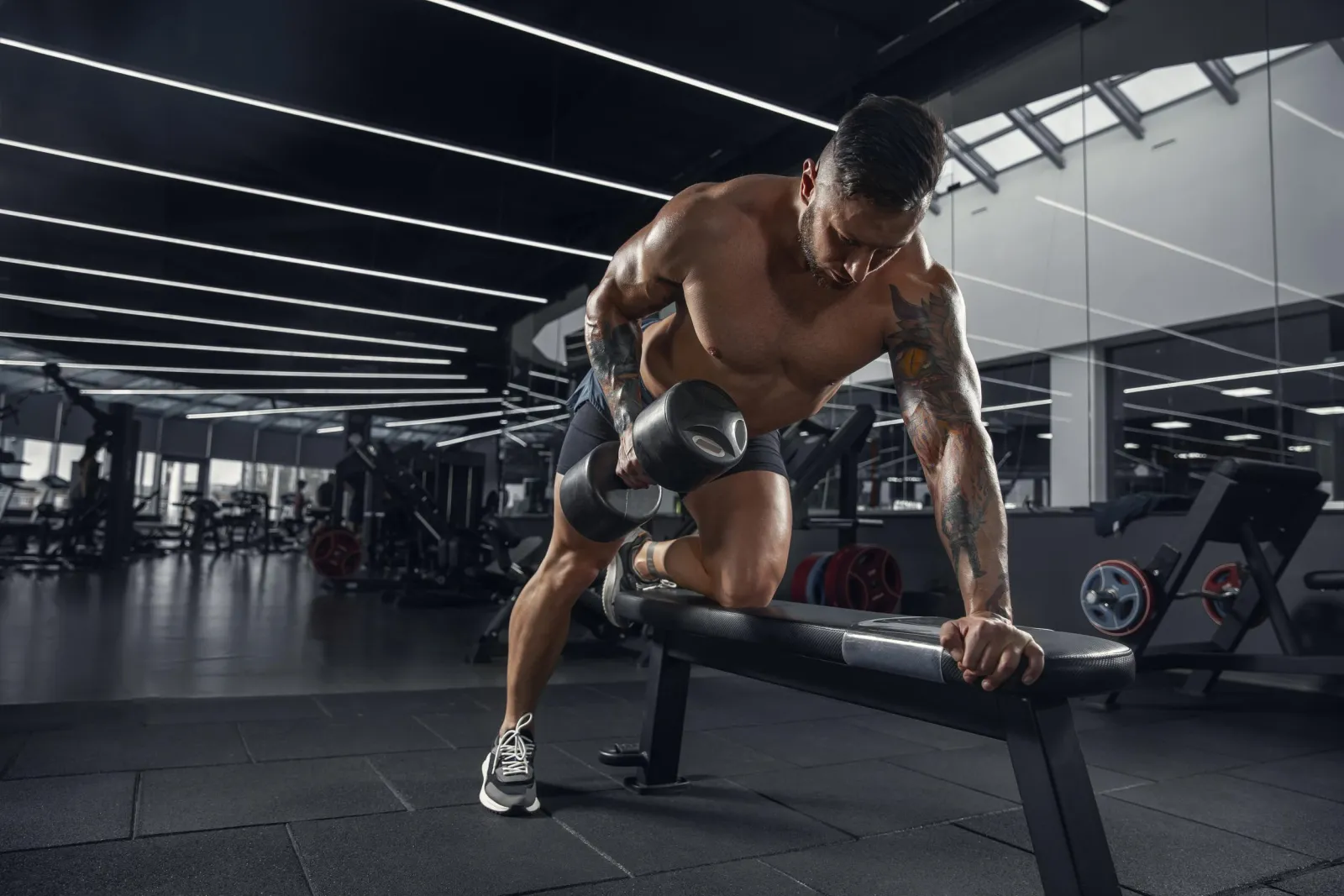 Athlete performing a dumbbell row on a bench
